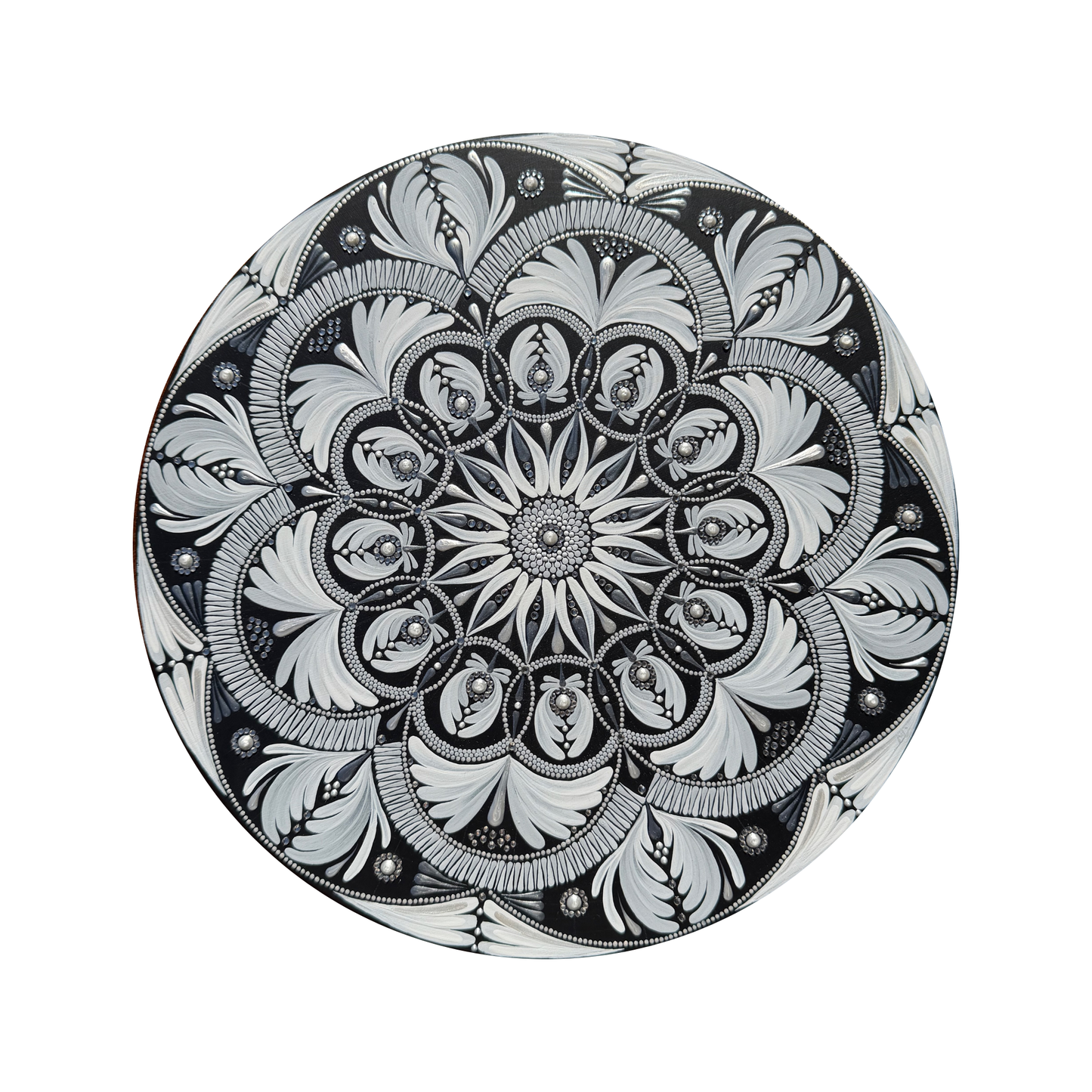 Decorative mandala with intricate black and white floral pattern on a white background
