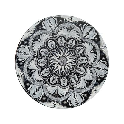 Decorative mandala with intricate black and white floral pattern on a white background