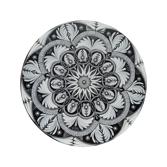 Decorative mandala with intricate black and white floral pattern on a white background