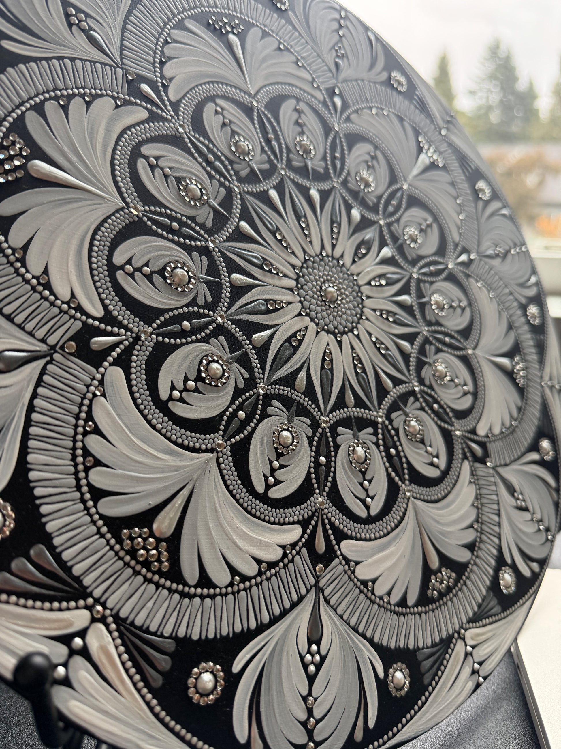 Close-up of a decorative mandala with intricate patterns and embellishments.