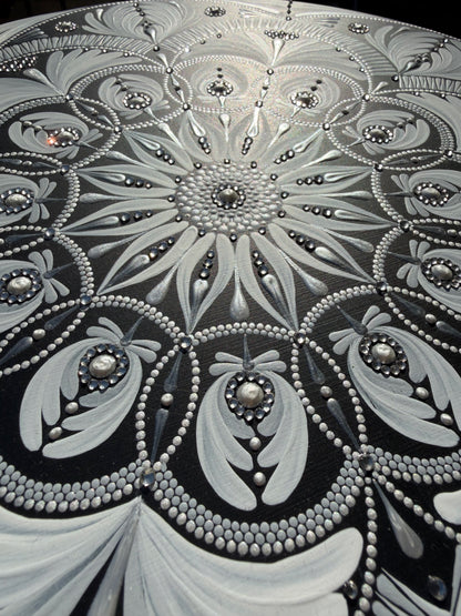 Close-up of a decorative mandala with intricate patterns and embellishments.