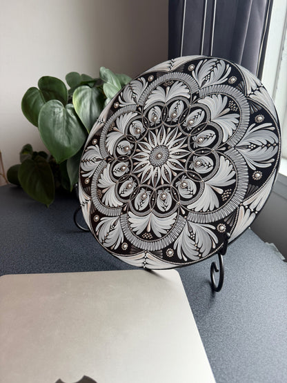 Decorative mandala with intricate black and white floral pattern on a white background