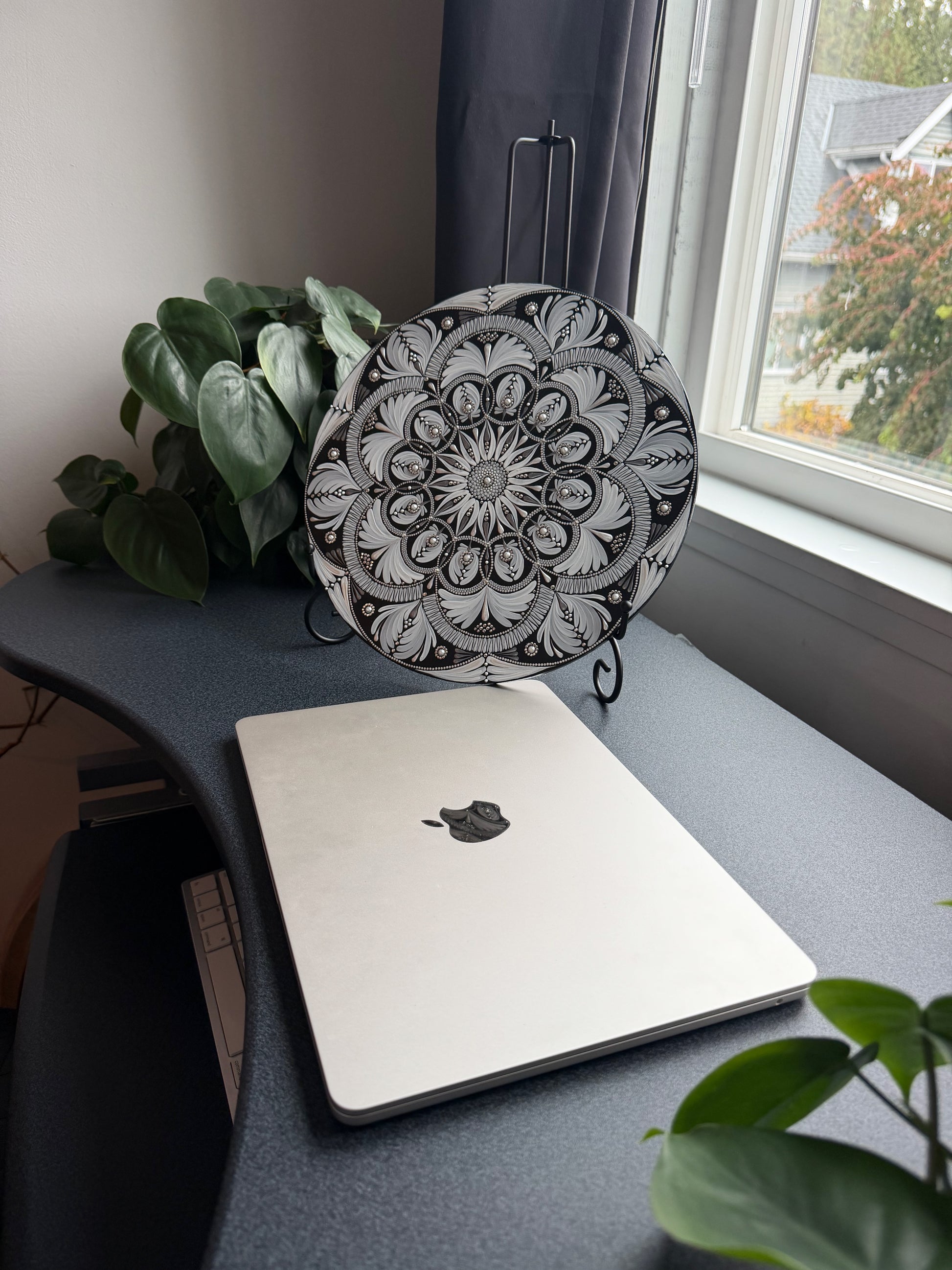 Decorative mandala with intricate black and white floral pattern on a white background